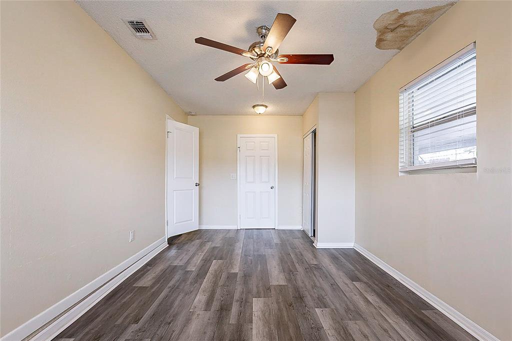 8528 Gold Ridge Circle Tampa, FL 33619 - Photo 27 of 31 wooden floor in an empty room with a window