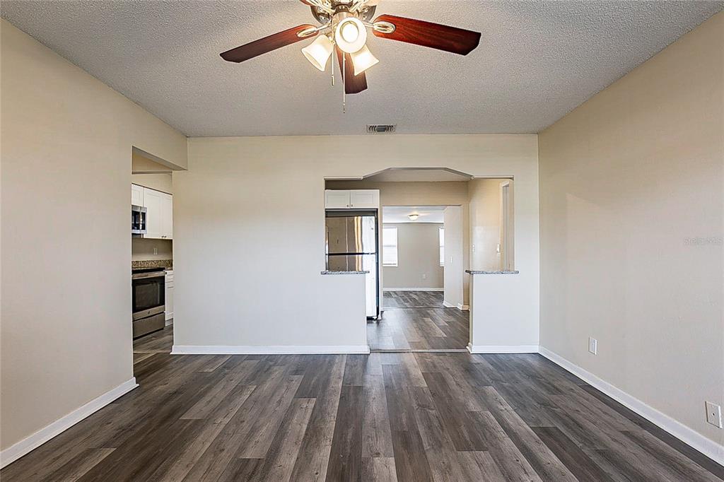 8528 Gold Ridge Circle Tampa, FL 33619 - Photo 4 of 31 wooden floor in an empty room with a window