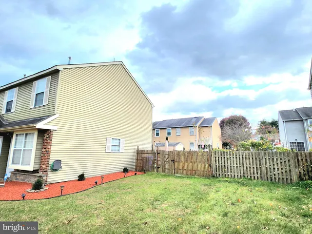 a view of a house with a yard and deck
