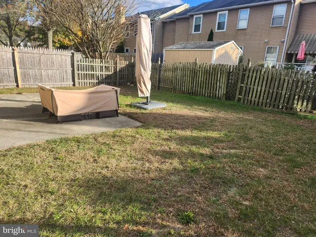 a view of a backyard with iron fence