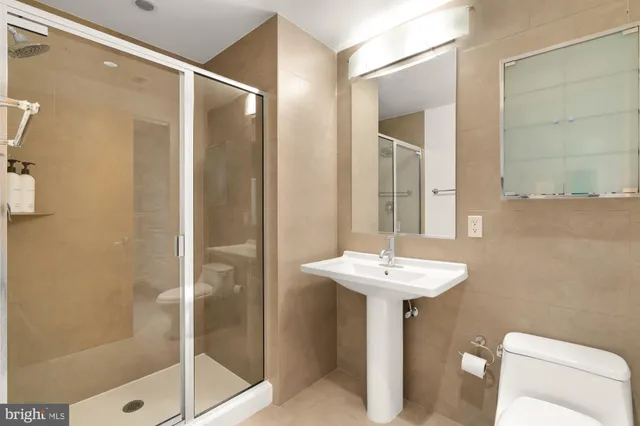 a bathroom with a sink toilet and shower