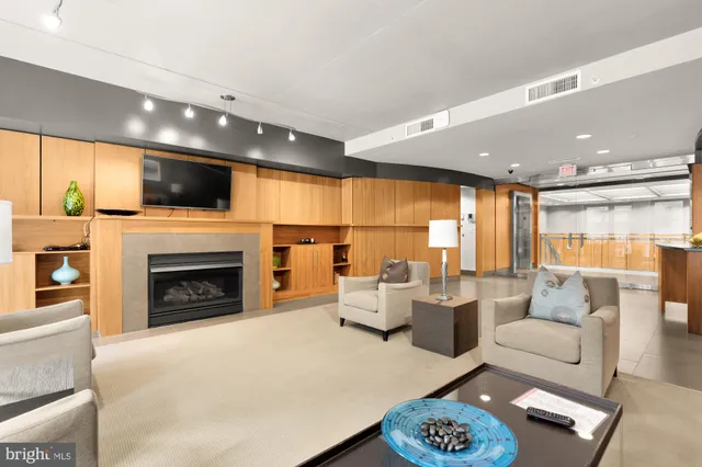 a living room with furniture fireplace and flat screen tv