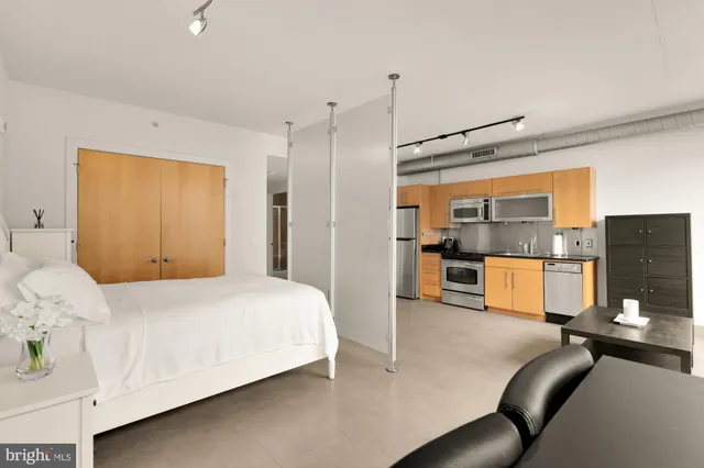 a bedroom with a bed couch and window