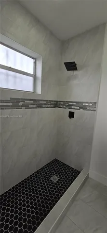 a bathroom with a glass door shower