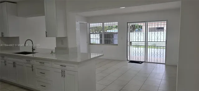 a kitchen with a sink and cabinets
