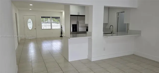 an empty room with windows and cabinet