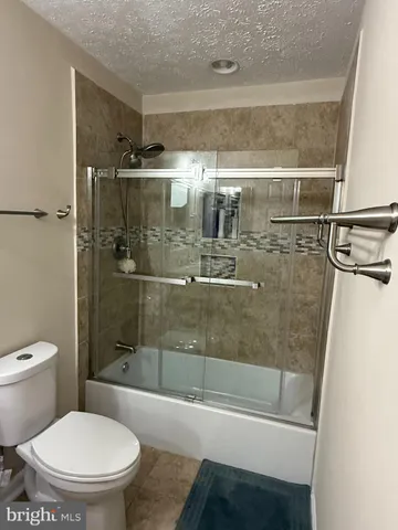 a bathroom with a shower a toilet and a sink