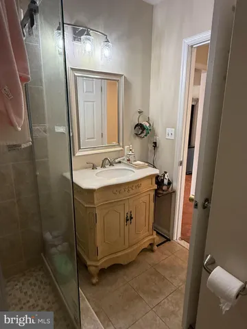 a bathroom with a sink a mirror and shower