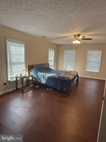 a spacious bedroom with a bed and a chandelier