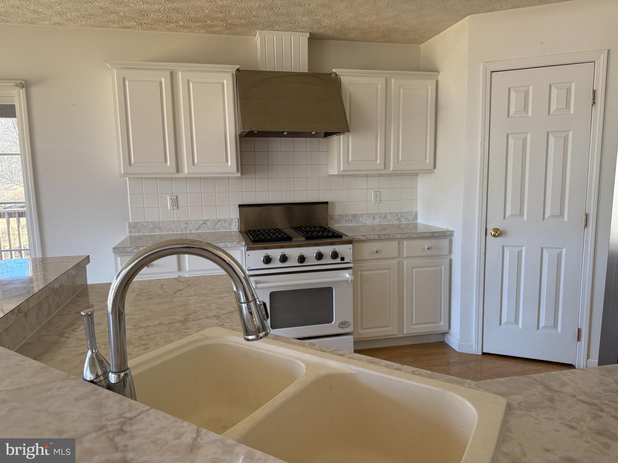 19322 Old Dans Rock Road Southwest Frostburg, MD 21532 - Photo 19 of 67 a kitchen with stainless steel appliances granite countertop a stove a sink and a microwave