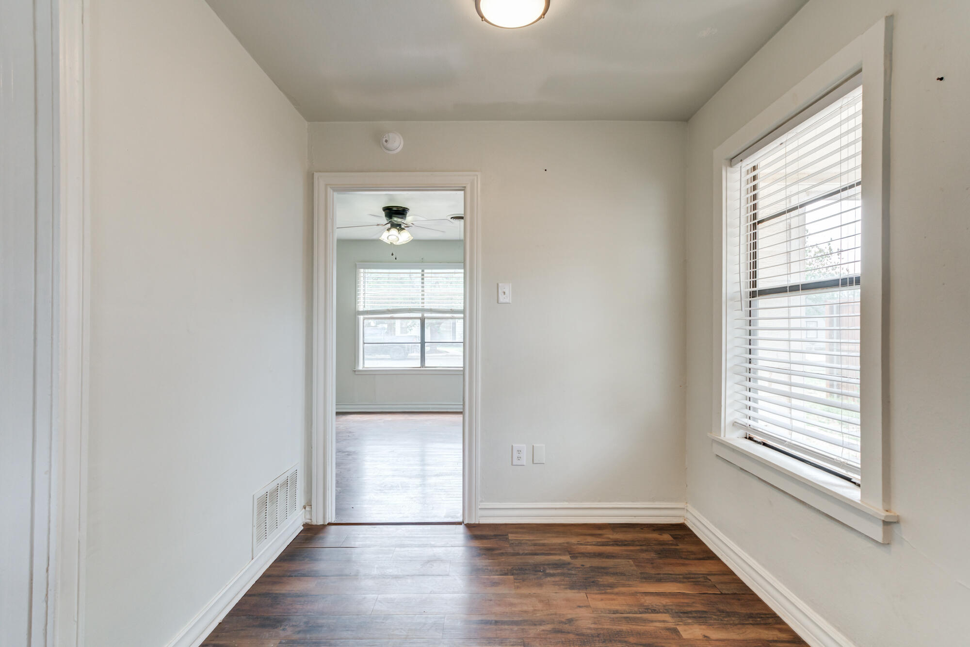 2308 30th Street Lubbock, TX 79411 - Photo 14 of 21 an empty room with wooden floor and windows