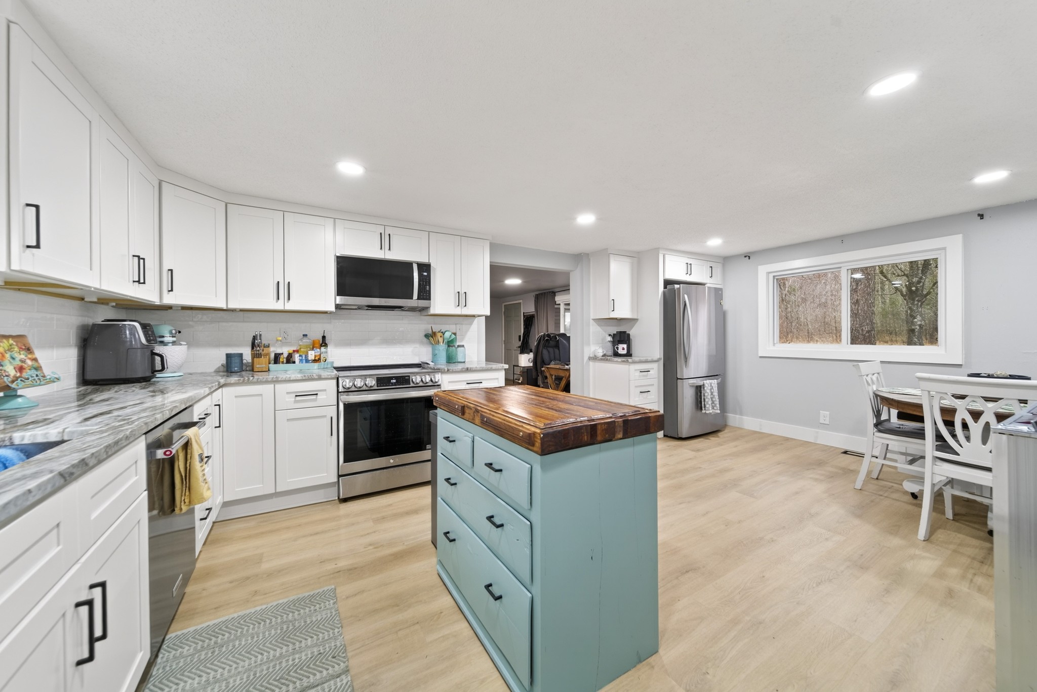 a kitchen with a stove a sink and a refrigerator
