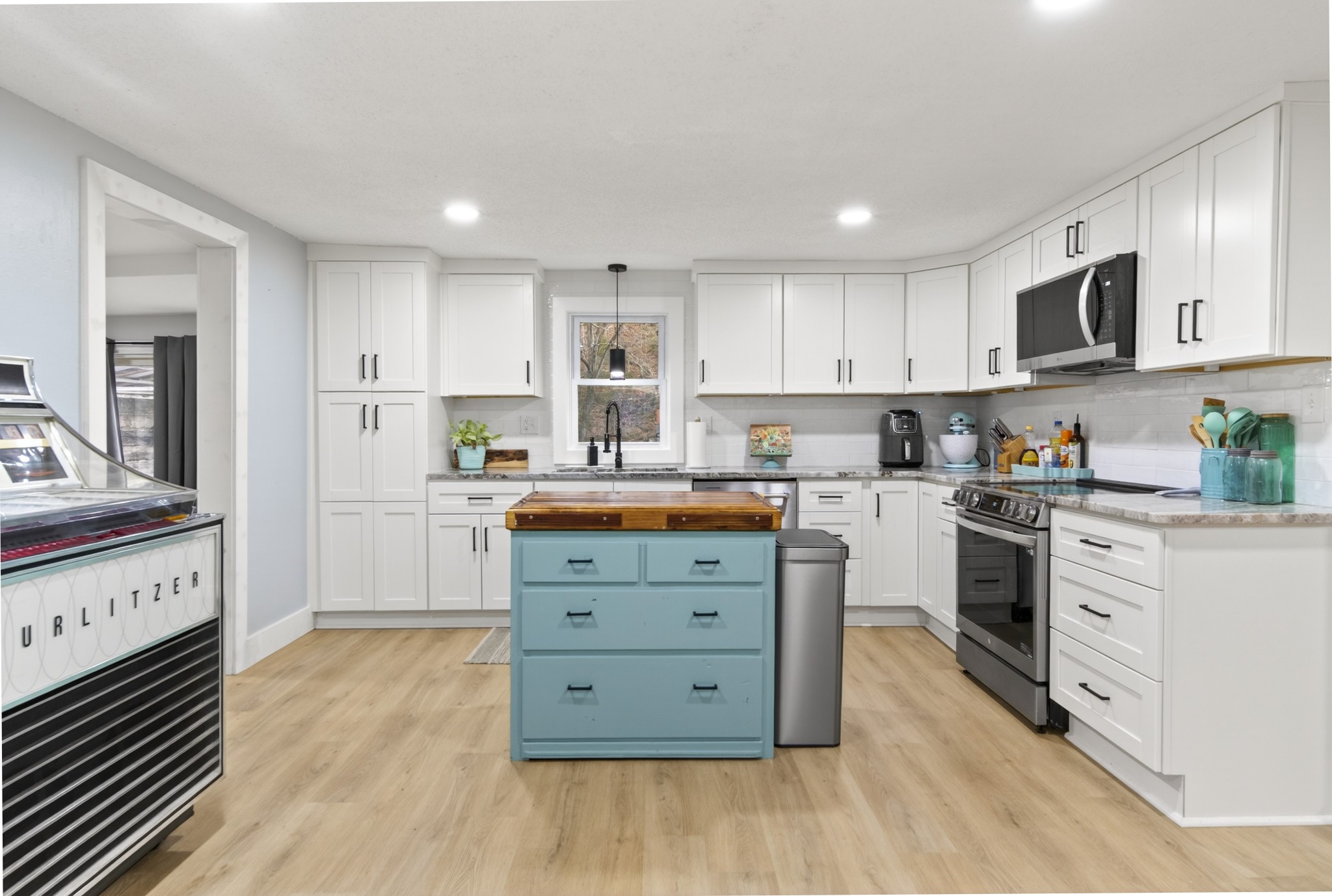 3332 Abednego Road Greenbrier, TN 37073 - Photo 48 of 86 a kitchen with stainless steel appliances granite countertop a stove top oven a sink dishwasher and a refrigerator with wooden floor