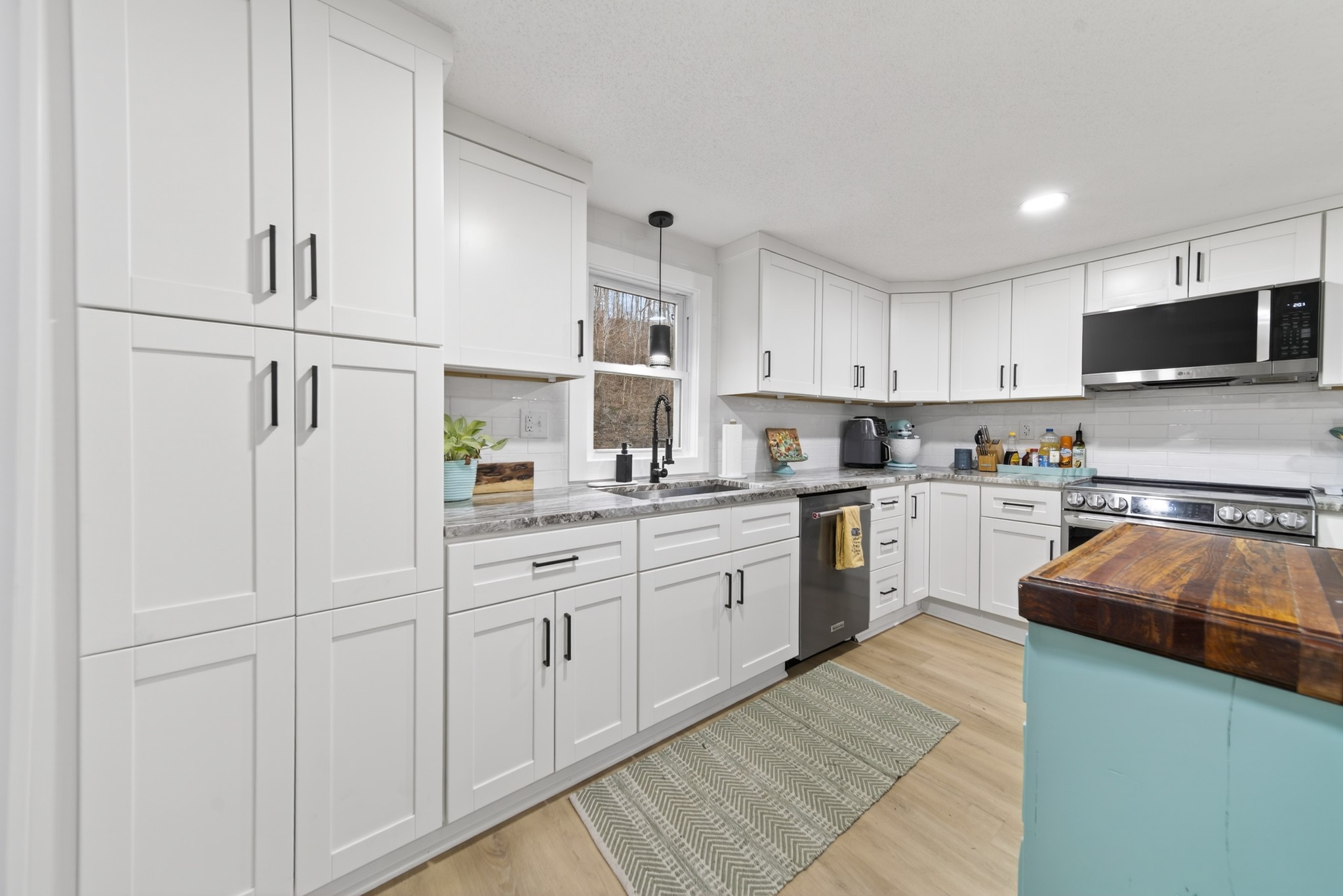 3332 Abednego Road Greenbrier, TN 37073 - Photo 50 of 86 a kitchen with granite countertop white cabinets and white appliances
