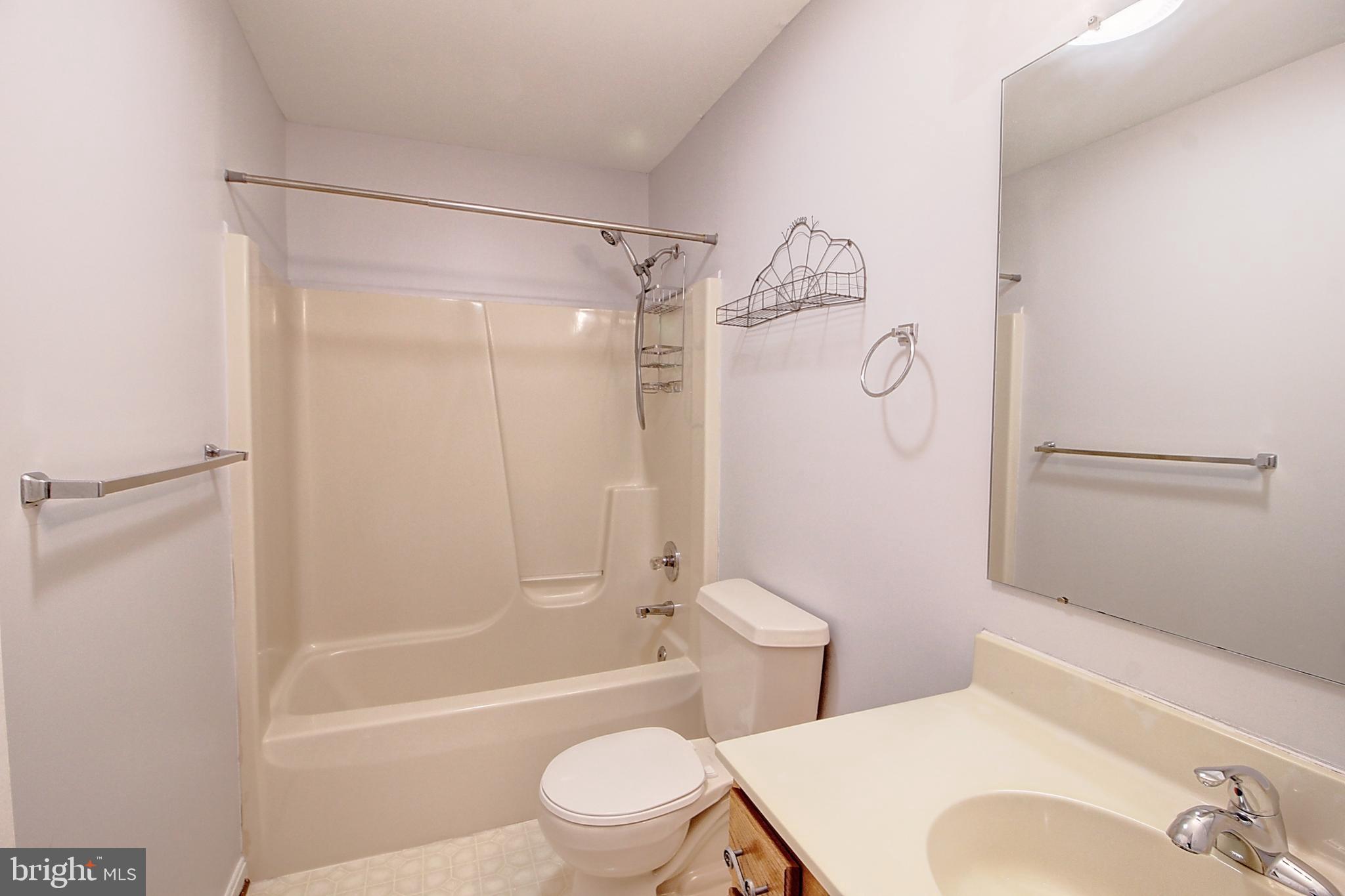 2415 Prentice Court Frederick, MD 21702 - Photo 18 of 20 a white toilet sitting next to a bath tub