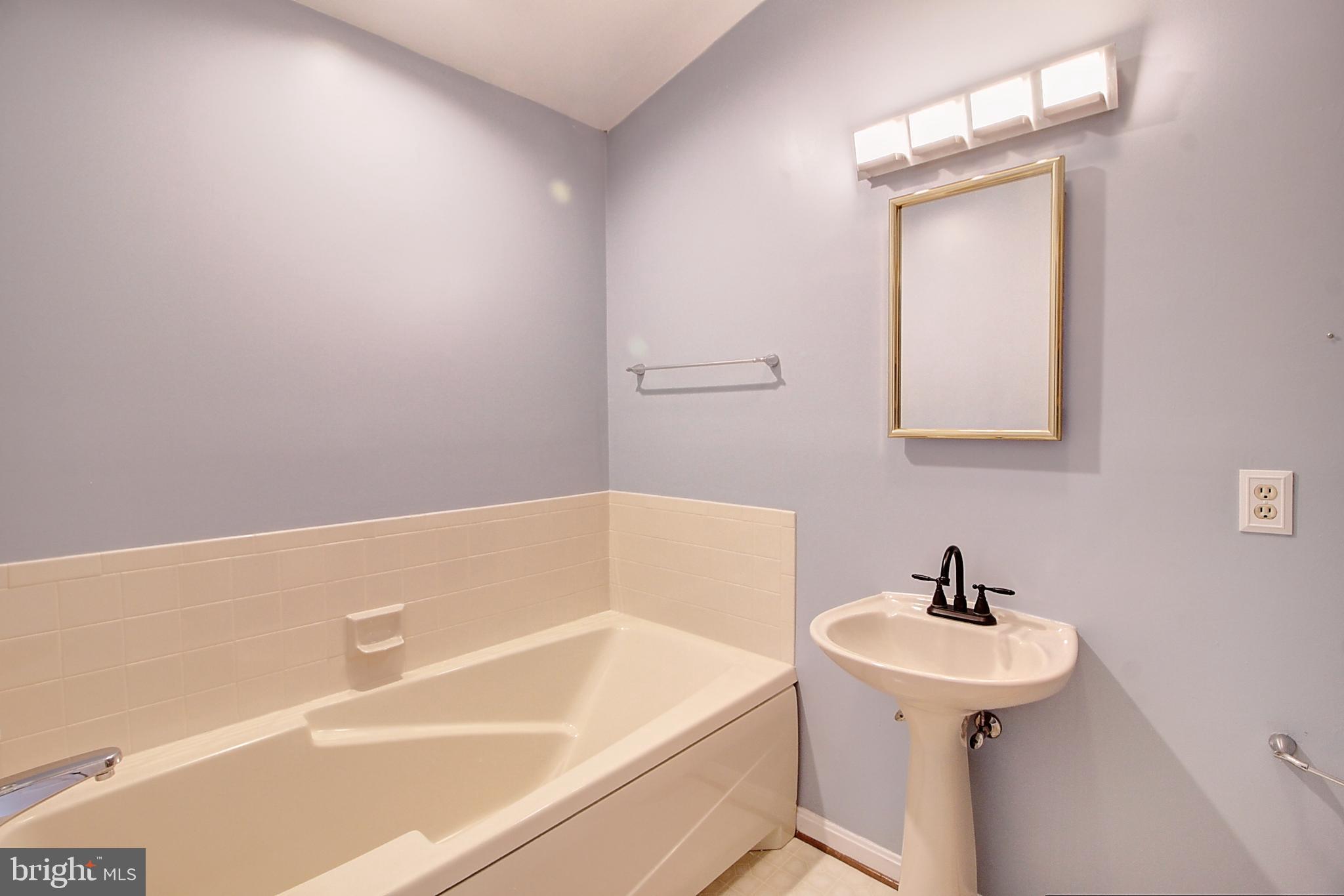 2415 Prentice Court Frederick, MD 21702 - Photo 19 of 20 a bathroom with a sink a toilet and shower