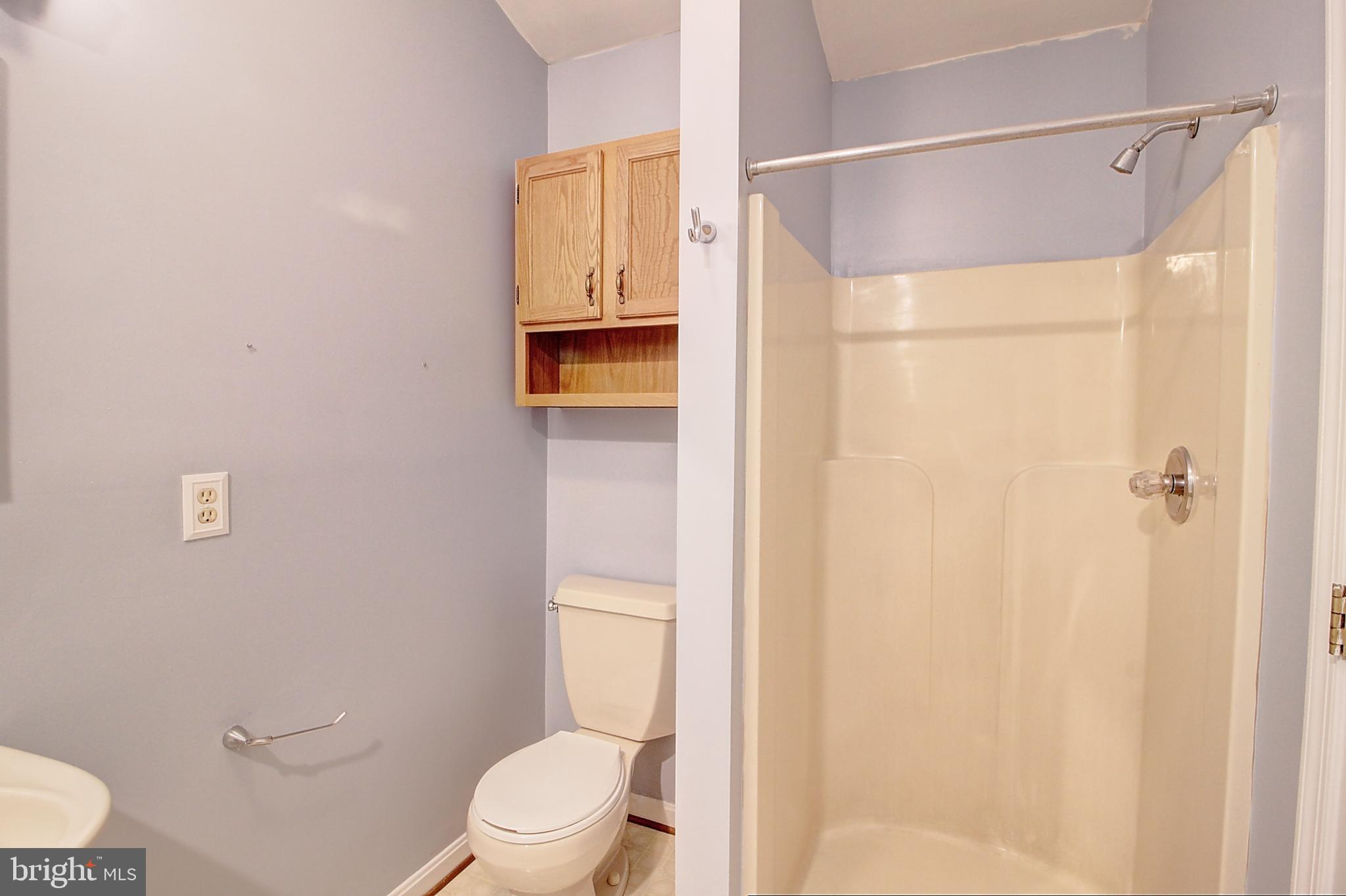 2415 Prentice Court Frederick, MD 21702 - Photo 20 of 20 a white toilet sitting next to a bathroom sink