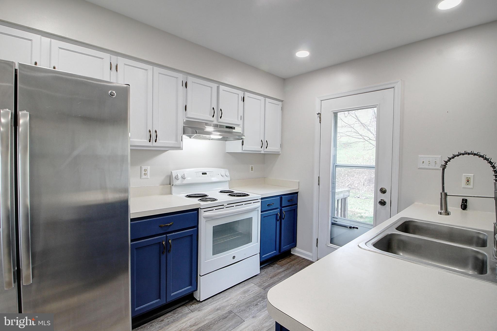 2415 Prentice Court Frederick, MD 21702 - Photo 6 of 20 a kitchen with stainless steel appliances a sink stove and refrigerator