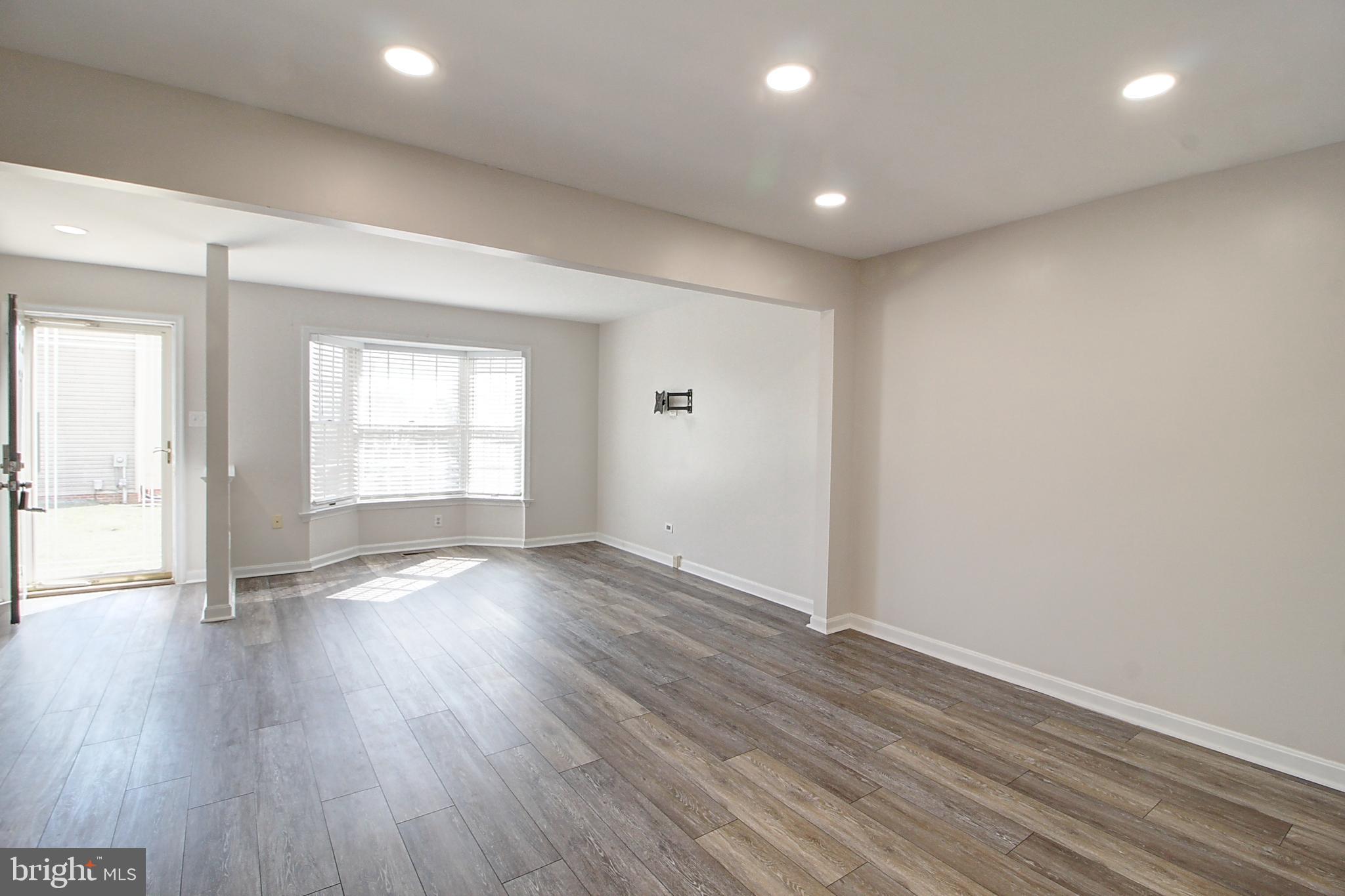 2415 Prentice Court Frederick, MD 21702 - Photo 8 of 20 an empty room with wooden floor and windows