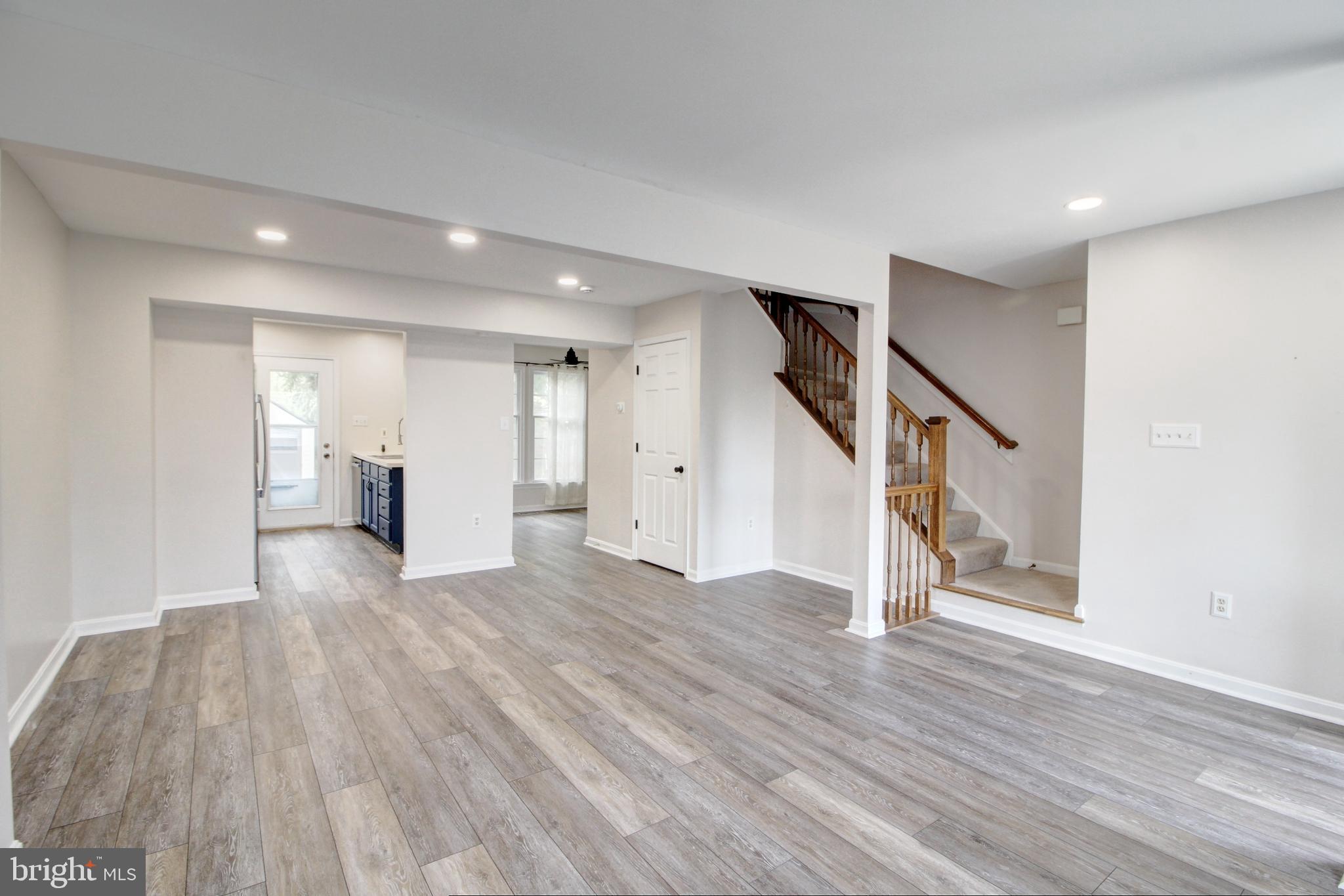 2415 Prentice Court Frederick, MD 21702 - Photo 9 of 20 a view of an empty room with wooden floor and stairs