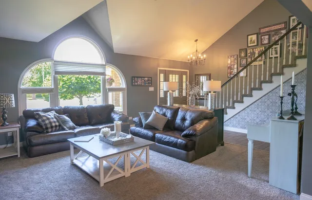 a kitchen with stainless steel appliances granite countertop a refrigerator a oven a stove and a wooden floors