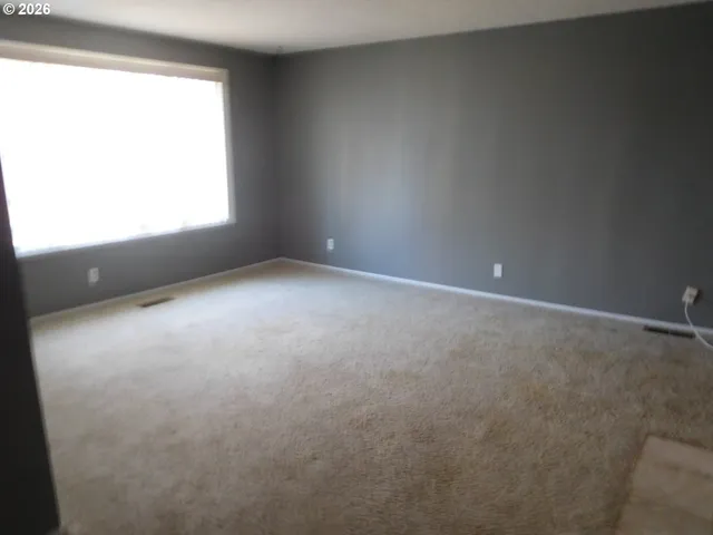 a view of an empty room and a window