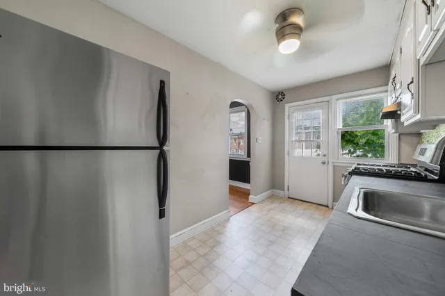 a view of a kitchen with a sink dishwasher and a refrigerator