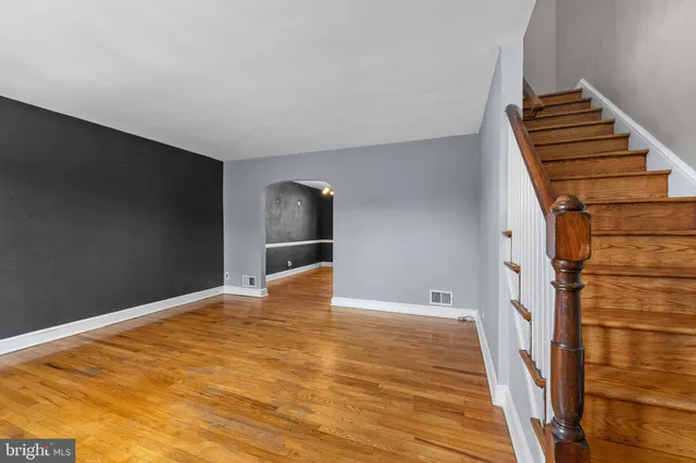 a view of an empty room with wooden floor