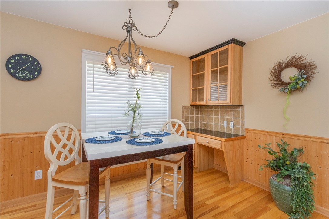 125 Inlet Pointe Drive Anderson, SC 29625 - Photo 12 of 39 An inviting dining area features warm wood paneling and a striking chandelier.