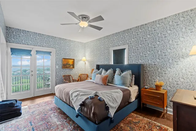 a bedroom with a bed a chandelier and a window