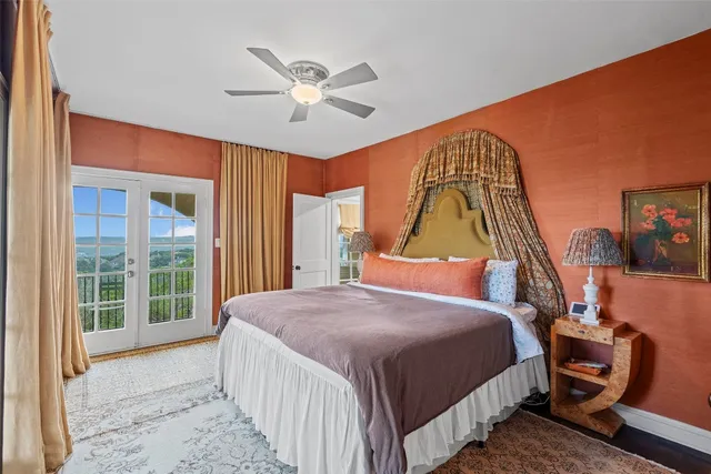 a bedroom with a bed a chandelier and a window