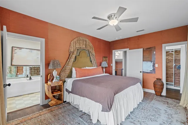 a bedroom with a bed a window and a chandelier