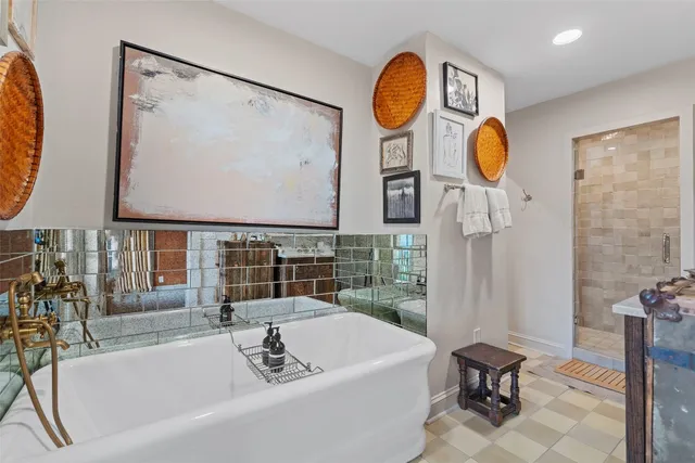 a bathroom with mirror and bathtub