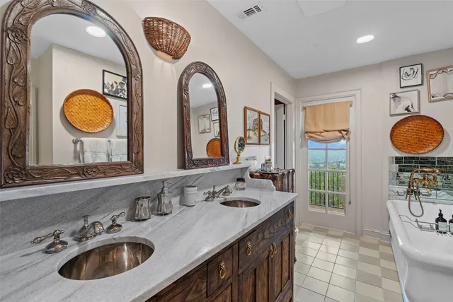 a bathroom with a granite countertop double vanity sink and a mirror