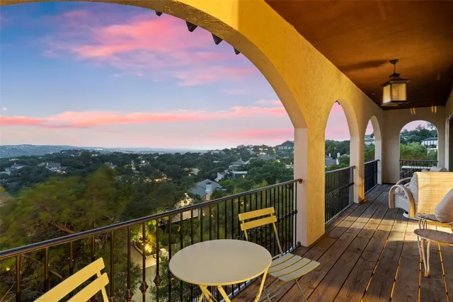 a view of a balcony with chair and wooden floor