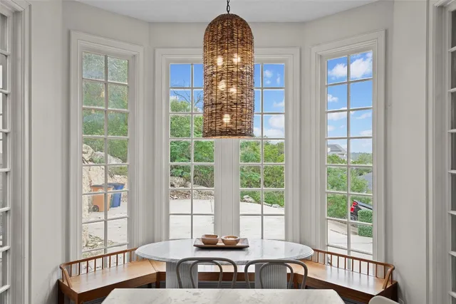 a view of a room with a large window and table