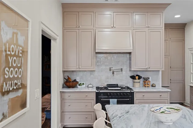 a kitchen with granite countertop white cabinets and appliances
