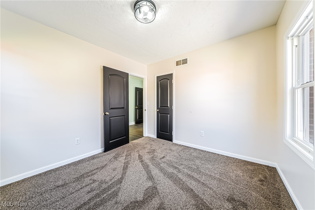 36336 Butternut Ridge Road North Ridgeville, OH 44039 - Photo 20 of 42 Unfurnished bedroom with a textured ceiling and dark colored carpet