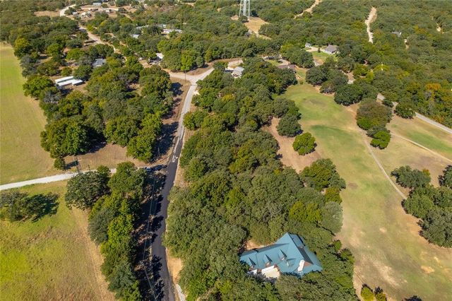 an aerial view of a house with a lake view