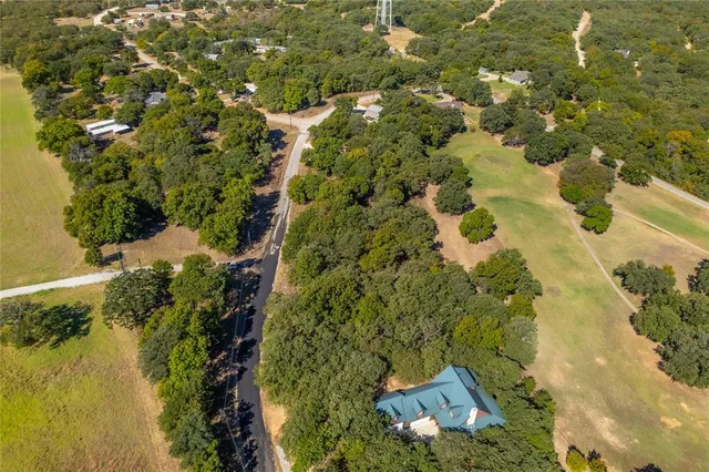 an aerial view of a house with a lake view