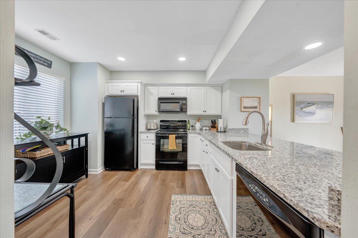 506 Harbor Ridge Drive Goodview, VA 24095 - Photo 13 of 39 a large kitchen with stainless steel appliances granite countertop a refrigerator and a stove top oven