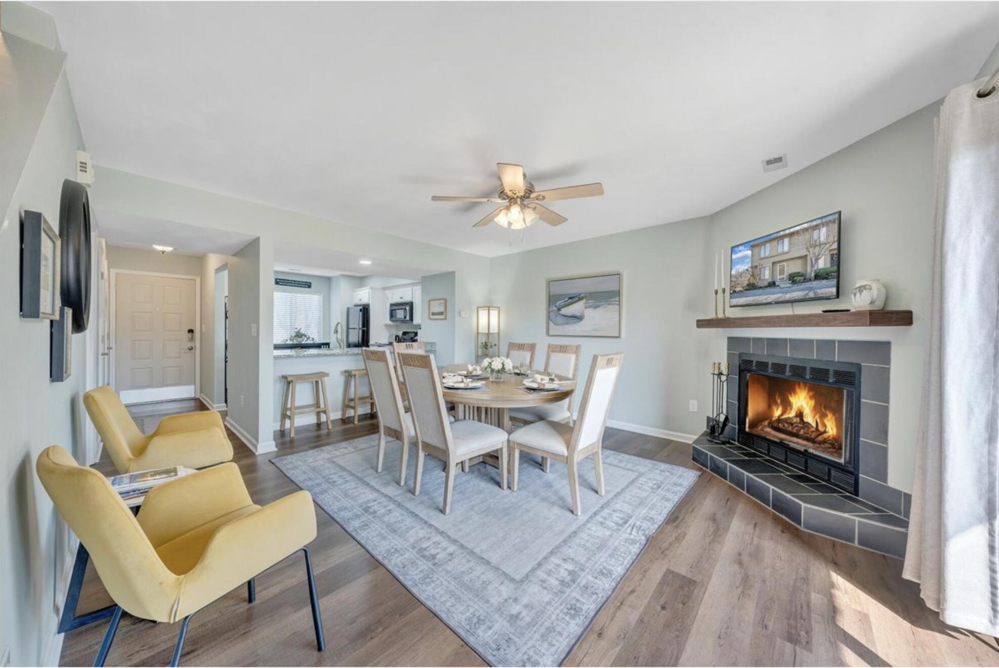 506 Harbor Ridge Drive Goodview, VA 24095 - Photo 17 of 39 a living room with furniture a fireplace and a flat screen tv