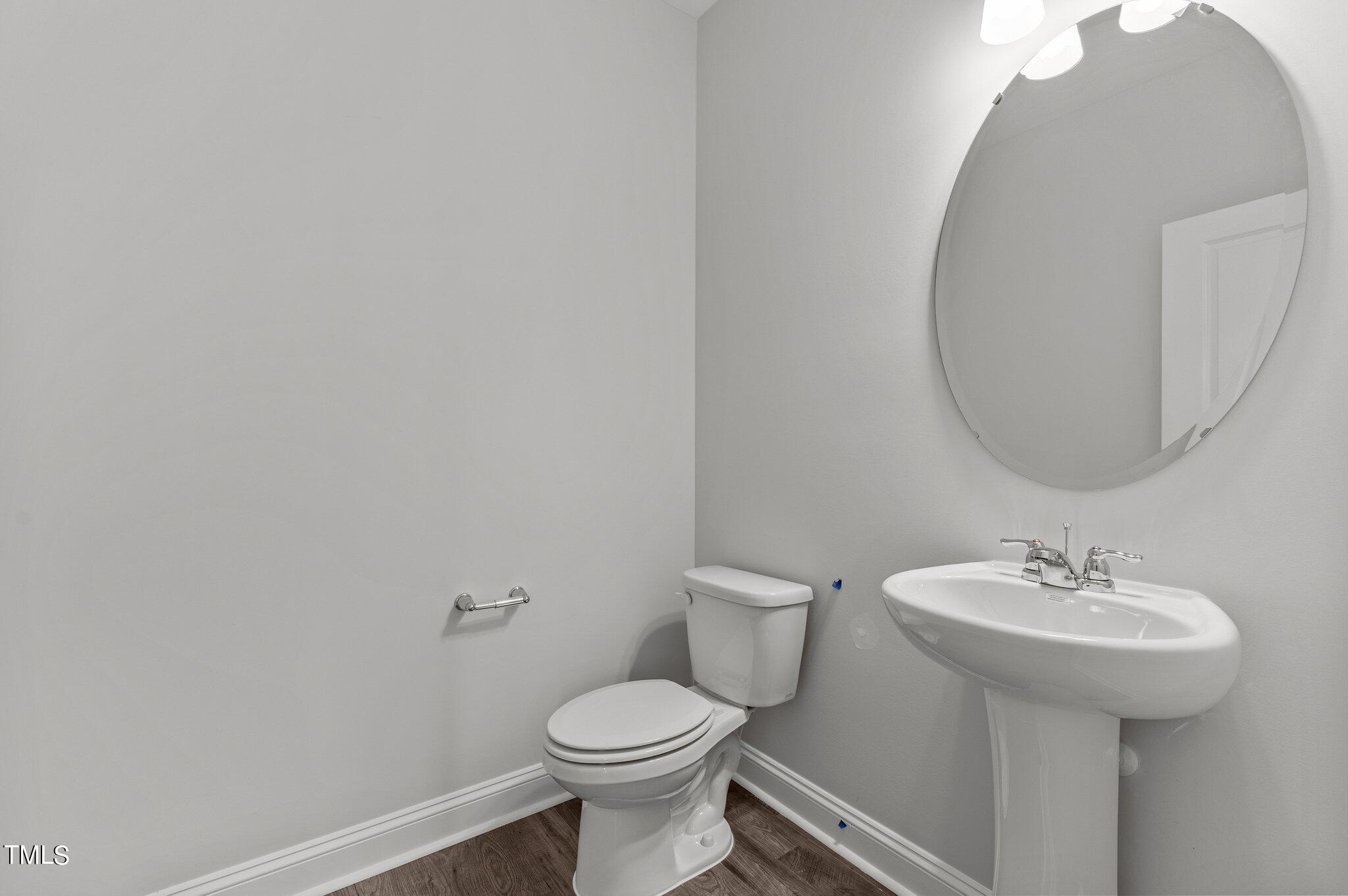 579 Forestville Road Wake Forest, NC 27587 - Photo 13 of 34 a bathroom with a sink toilet and a mirror