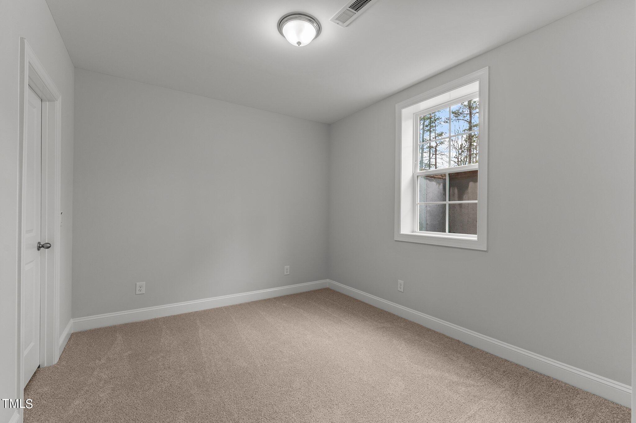 579 Forestville Road Wake Forest, NC 27587 - Photo 15 of 34 an empty room with windows