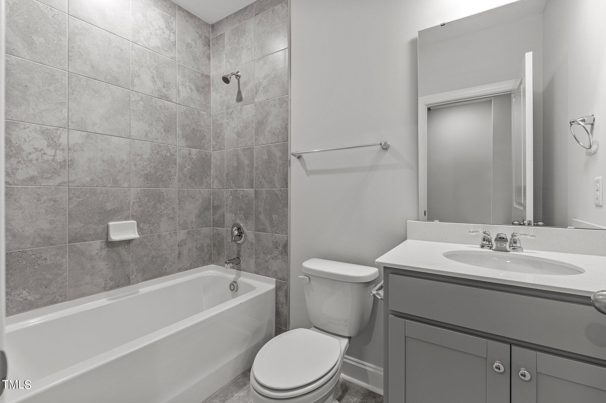 579 Forestville Road Wake Forest, NC 27587 - Photo 16 of 34 a bathroom with a sink a toilet and shower