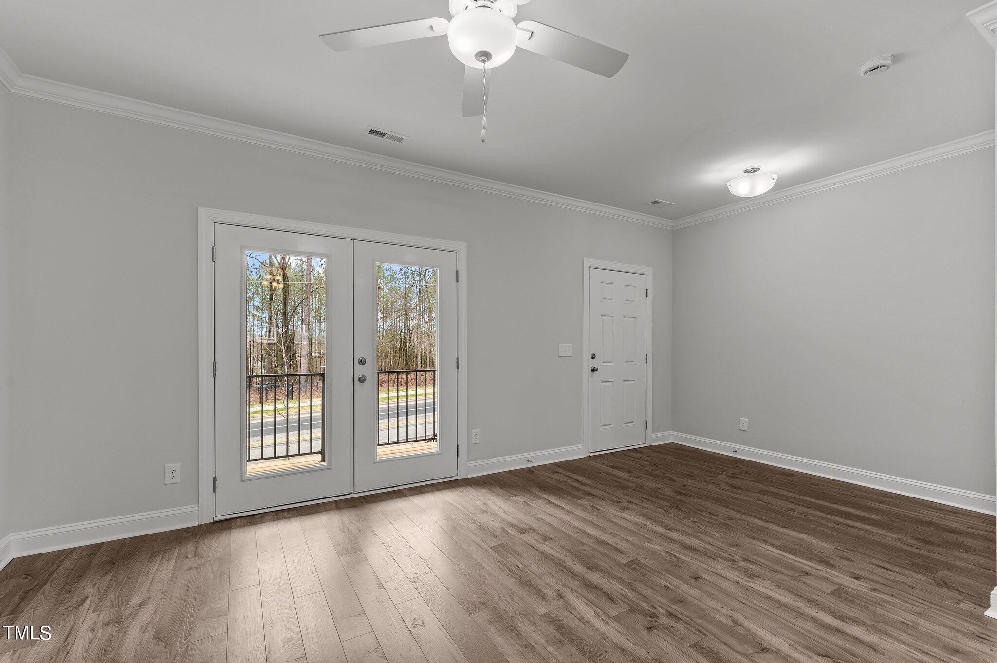 579 Forestville Road Wake Forest, NC 27587 - Photo 2 of 34 a view of an empty room with wooden floor and a window