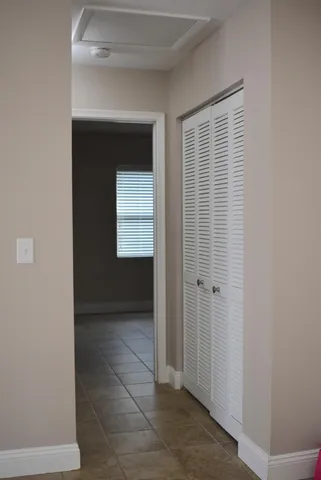 a view of hallway with a sink and a window