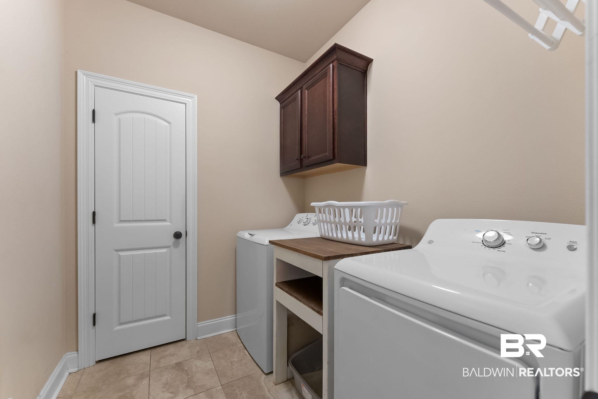 7015 Rocky Rd Loop Gulf Shores, AL 36542 - Photo 35 of 41 Laundry room featuring cabinet space, light tile patterned floors, and washing machine and clothes dryer