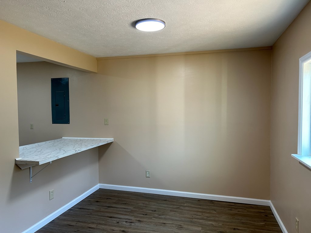 1300 Dr Brooks Road Box Springs, GA 31801 - Photo 13 of 16 a view of an empty room with wooden floor and a window