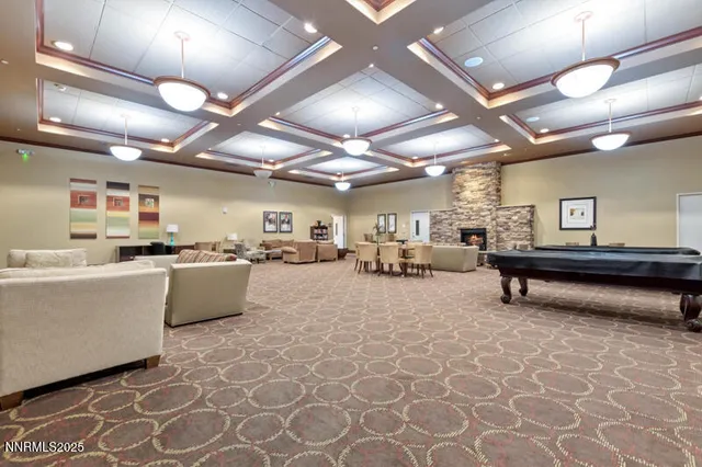 a living room with lots of furniture and kitchen view